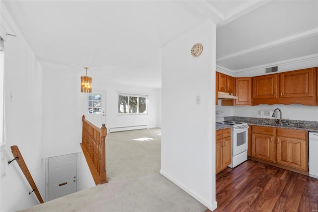 kitchen with white appliances, a sink, under cabinet range hood, a baseboard heating unit, and brown cabinetry