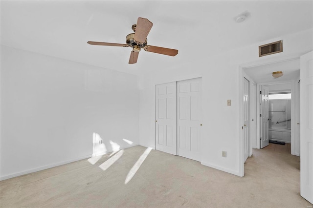 unfurnished bedroom featuring carpet floors, a closet, baseboards, and a ceiling fan