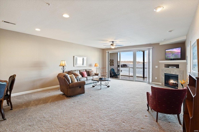 18051 Blue Anchor Dr Unit 522, Gravois Mills, MO 65037 - carpeted living room with baseboards, a warm lit fireplace, a ceiling fan, a textured ceiling, and recessed lighting