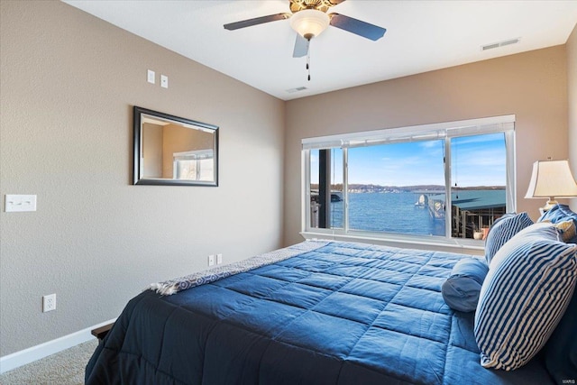 18051 Blue Anchor Dr Unit 522, Gravois Mills, MO 65037 - bedroom with carpet, baseboards, a textured wall, a ceiling fan, and a water view
