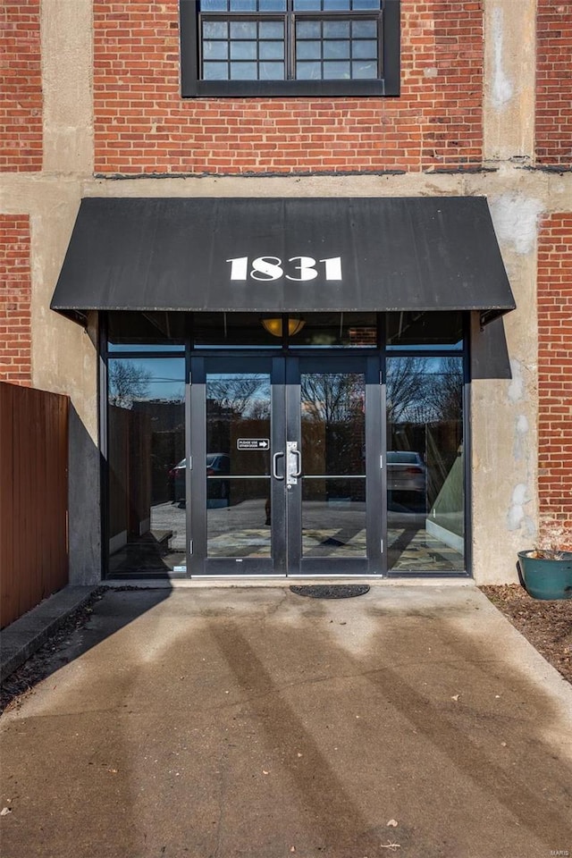 property entrance with french doors and brick siding