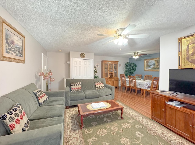 3253 Leisurewood Ct Unit G, Florissant, MO 63033 - living room with ceiling fan, light wood-style floors, and a textured ceiling