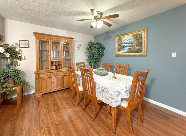 3253 Leisurewood Ct Unit G, Florissant, MO 63033 - dining area featuring light wood-style floors, a ceiling fan, baseboards, and a textured ceiling
