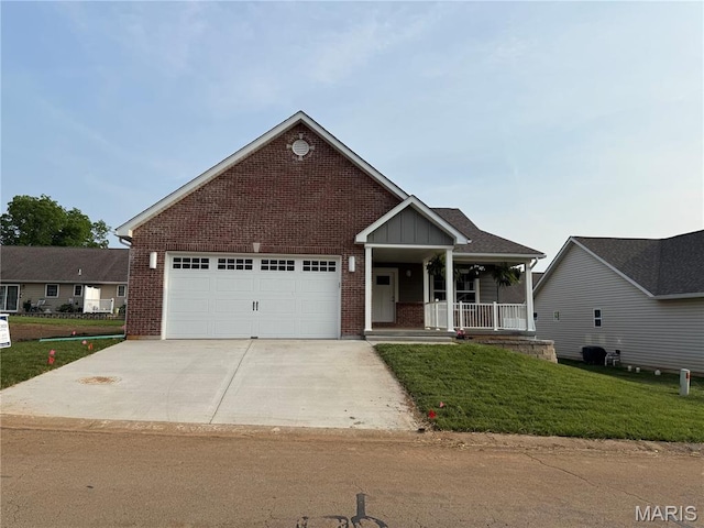 40 Butterfield, Farmington, MO 63640 - view of front of home featuring brick siding, concrete driveway, covered porch, and a front lawn