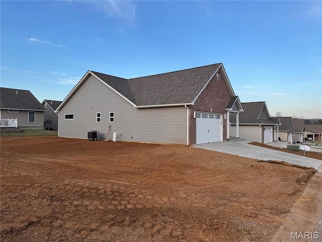 40 Butterfield, Farmington, MO 63640 - view of side of home with an attached garage, driveway, and brick siding
