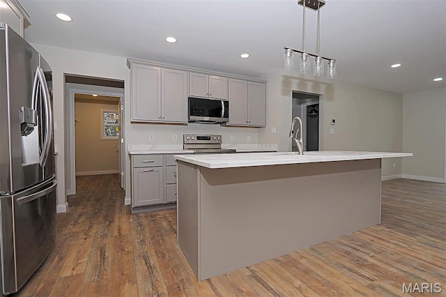 40 Butterfield, Farmington, MO 63640 - kitchen with appliances with stainless steel finishes, gray cabinets, light countertops, dark wood finished floors, and baseboards