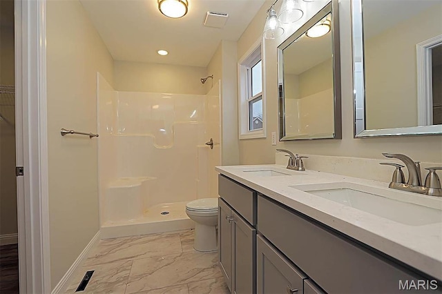 40 Butterfield, Farmington, MO 63640 - bathroom featuring marble look tile flooring, toilet, double vanity, a shower, and baseboards