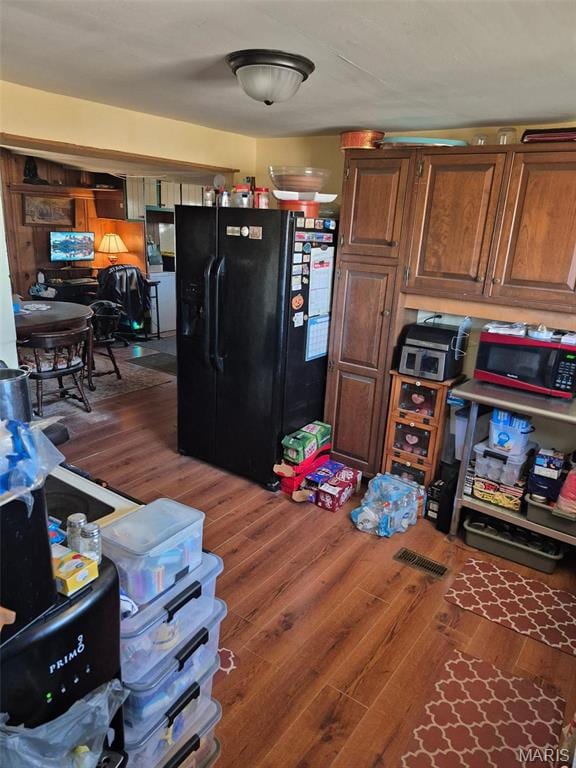 169 Clover Ln, Bourbon, MO 65441 - kitchen featuring black fridge and wood finished floors