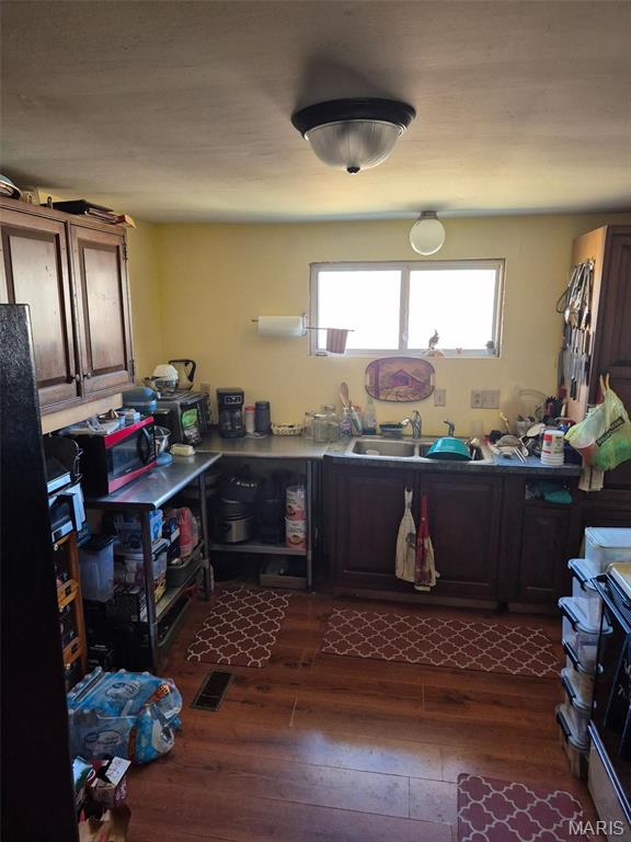 169 Clover Ln, Bourbon, MO 65441 - kitchen featuring dark wood finished floors, stainless steel microwave, and range
