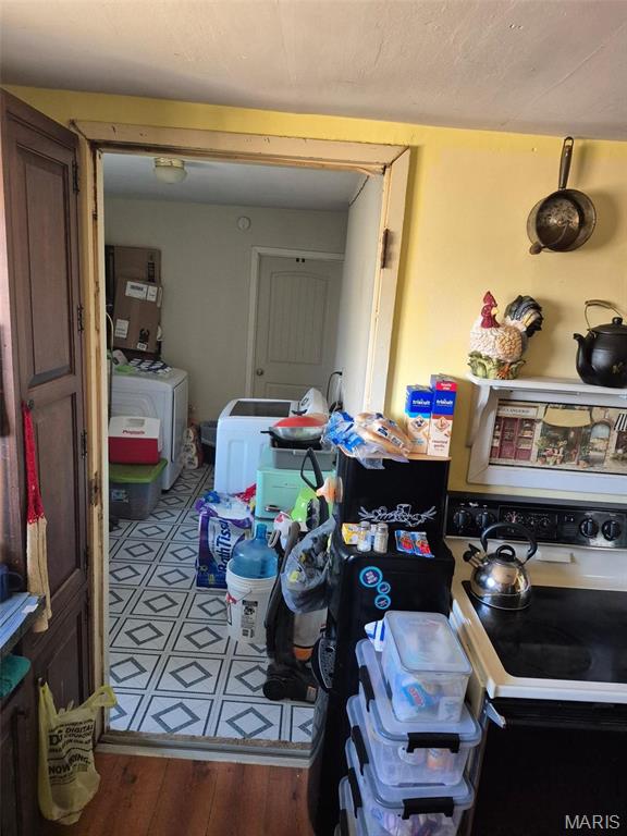 169 Clover Ln, Bourbon, MO 65441 - dining area featuring washer and clothes dryer and wood finished floors