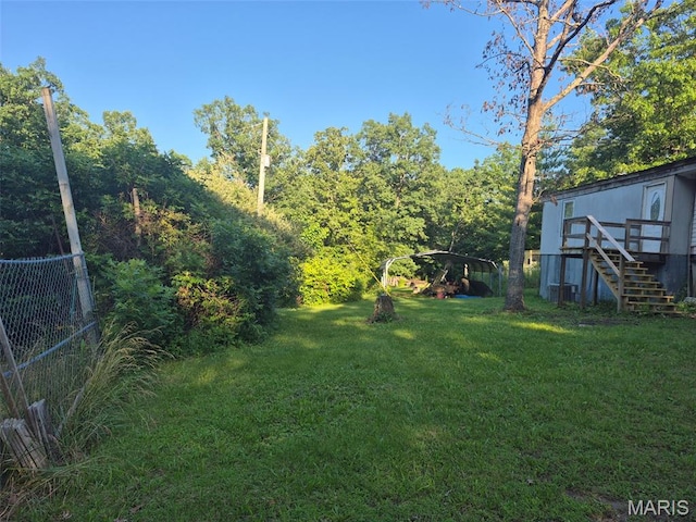 169 Clover Ln, Bourbon, MO 65441 - view of grassy yard featuring stairs, a detached carport, and a deck