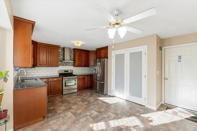 2537 Castle Pines Dr, Imperial, MO 63052 - kitchen featuring stainless steel appliances, a sink, wall chimney range hood, a ceiling fan, and decorative backsplash