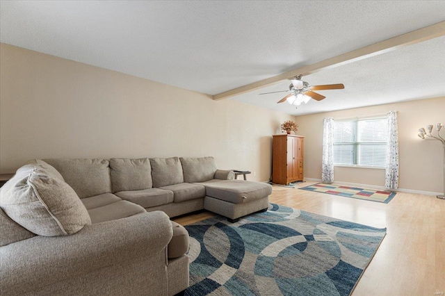 2537 Castle Pines Dr, Imperial, MO 63052 - living area with wood finished floors, a ceiling fan, beamed ceiling, and baseboards