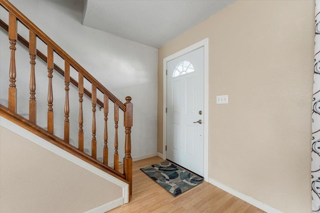 2537 Castle Pines Dr, Imperial, MO 63052 - entryway featuring wood finished floors, baseboards, and stairway