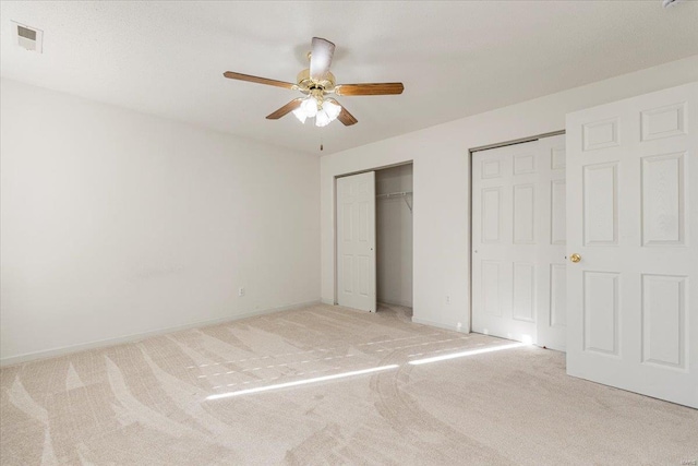 2537 Castle Pines Dr, Imperial, MO 63052 - unfurnished bedroom with two closets, light carpet, baseboards, and a ceiling fan