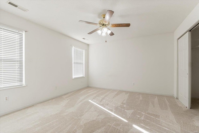 2537 Castle Pines Dr, Imperial, MO 63052 - unfurnished bedroom featuring light colored carpet, baseboards, a ceiling fan, and a closet