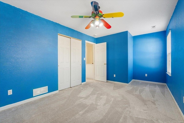 2537 Castle Pines Dr, Imperial, MO 63052 - unfurnished bedroom with carpet, baseboards, a closet, and ceiling fan