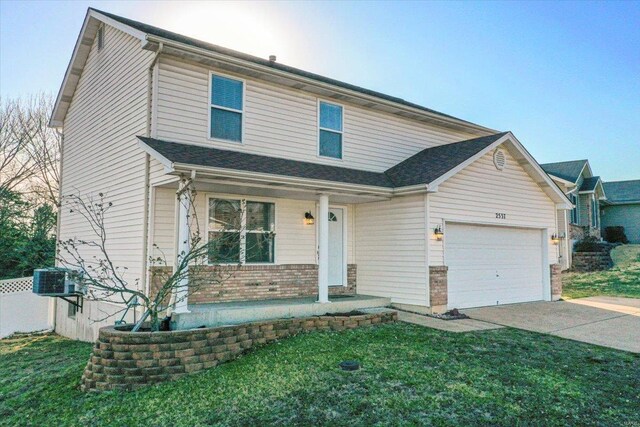 2537 Castle Pines Dr, Imperial, MO 63052 - traditional-style home featuring covered porch, concrete driveway, a garage, and a front yard