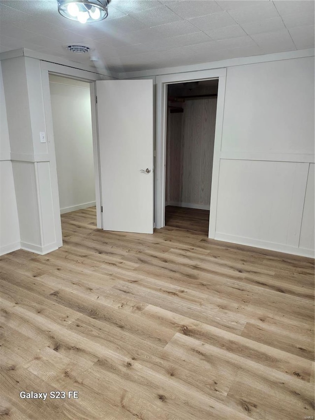972 Sunny Ridge Vw, Union, MO 63084 - unfurnished bedroom featuring light wood-style flooring, a decorative wall, and baseboards