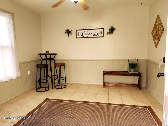 972 Sunny Ridge Vw, Union, MO 63084 - unfurnished dining area with a wainscoted wall, ceiling fan, and tile patterned flooring