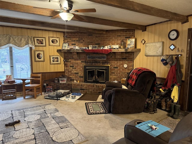 22755 Pin Oak Dr, Lebanon, MO 65536 - living room featuring a ceiling fan, beamed ceiling, carpet, wooden walls, and a brick fireplace