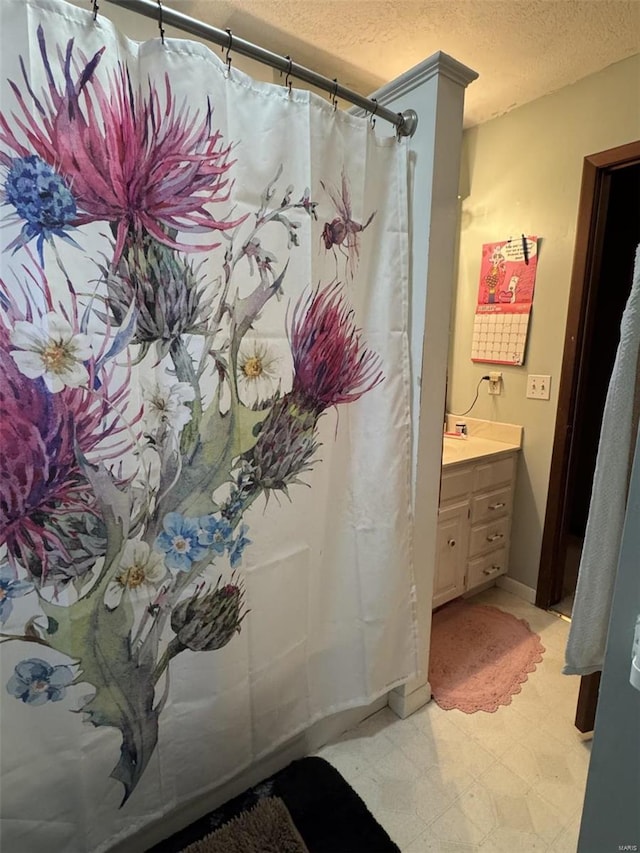 22755 Pin Oak Dr, Lebanon, MO 65536 - bathroom featuring a textured ceiling, vanity, and tile patterned floors