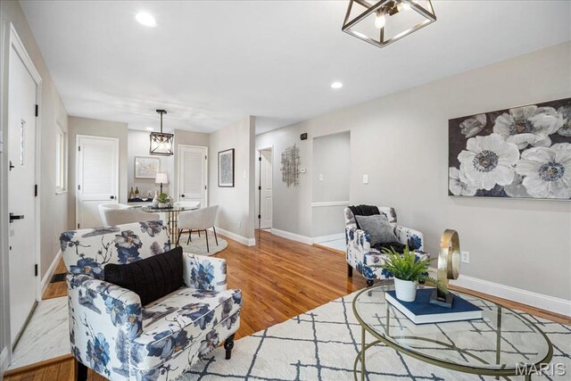 4501 Conleth Dr, Saint Louis, MO 63129 - living area featuring wood finished floors, baseboards, recessed lighting, and a chandelier