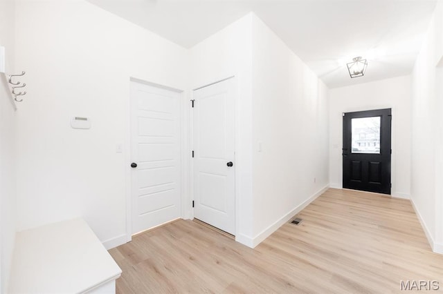 entrance foyer featuring light wood finished floors and baseboards