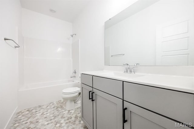 full bath featuring toilet, vanity, and tub / shower combination