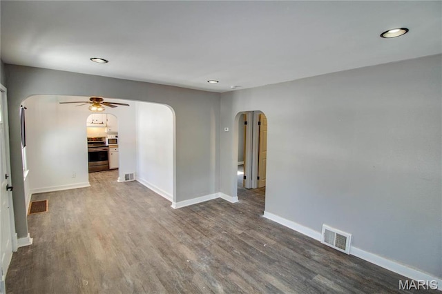 330 Grant St, Bethalto, IL 62010 - empty room with arched walkways, ceiling fan, wood finished floors, baseboards, and recessed lighting