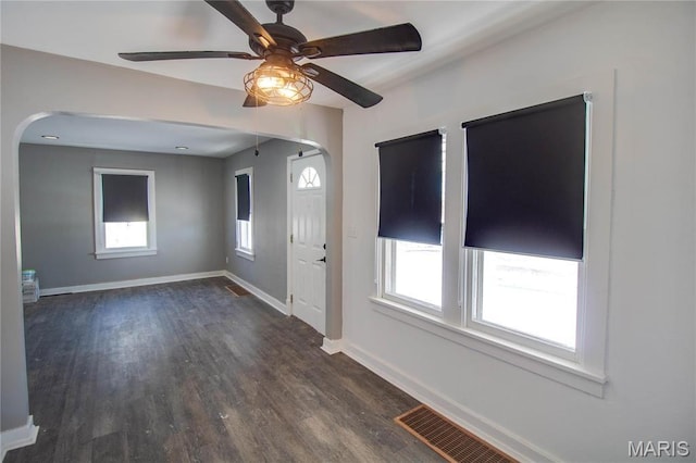 330 Grant St, Bethalto, IL 62010 - unfurnished room featuring arched walkways, wood finished floors, baseboards, and a ceiling fan