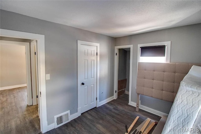 330 Grant St, Bethalto, IL 62010 - unfurnished bedroom featuring wood finished floors, baseboards, and a textured ceiling