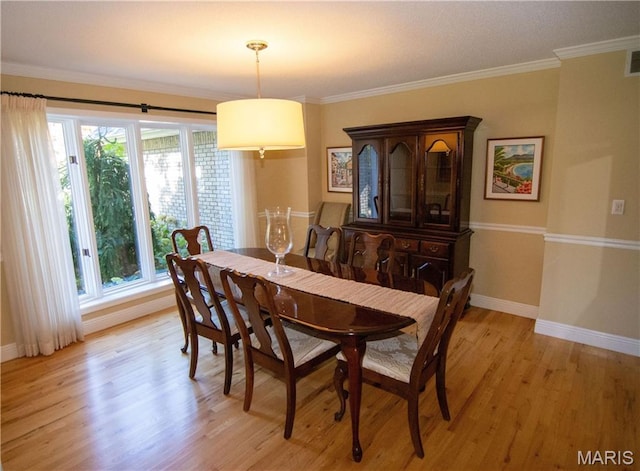 14342 N 1025th St, Effingham, IL 62401 - dining space with light wood-style floors, baseboards, and crown molding
