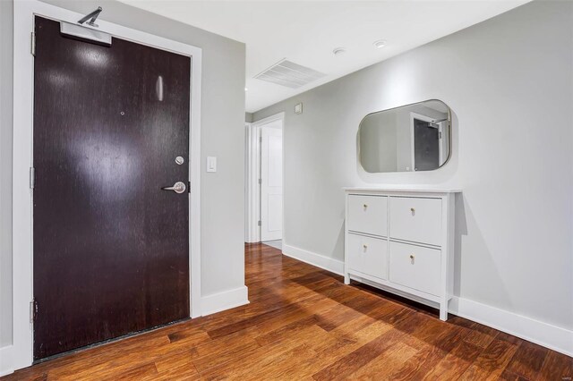 entryway featuring wood finished floors and baseboards