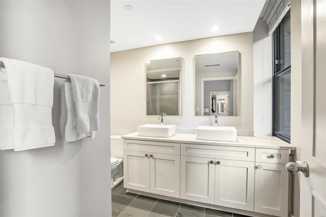 full bathroom featuring a stall shower, double vanity, toilet, tile patterned flooring, and recessed lighting