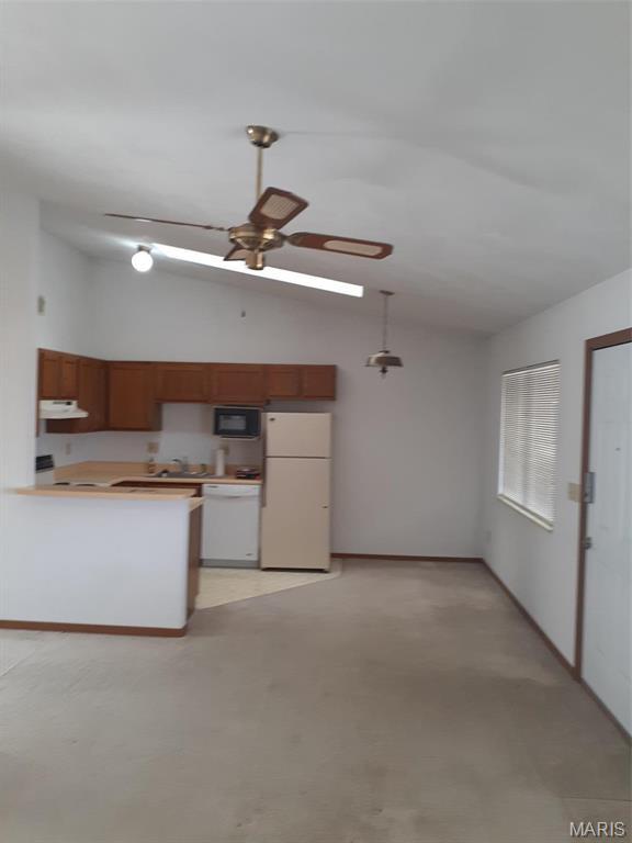 161 Eagle Rdg Unit 163-306, Ofallon, IL 62269 - kitchen featuring white appliances, under cabinet range hood, ceiling fan, a peninsula, and concrete flooring