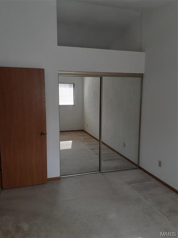 161 Eagle Rdg Unit 163-306, Ofallon, IL 62269 - unfurnished bedroom featuring a closet, baseboards, and carpet flooring