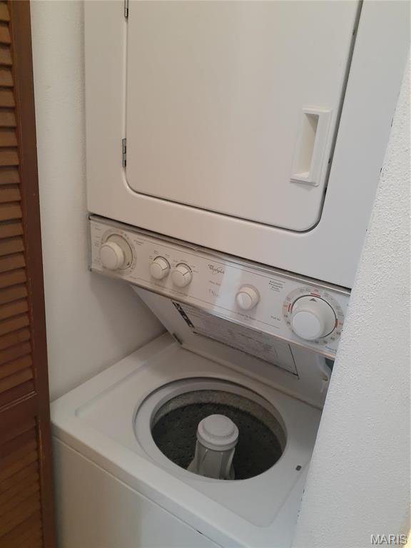 161 Eagle Rdg Unit 163-306, Ofallon, IL 62269 - washroom featuring stacked washing machine and dryer