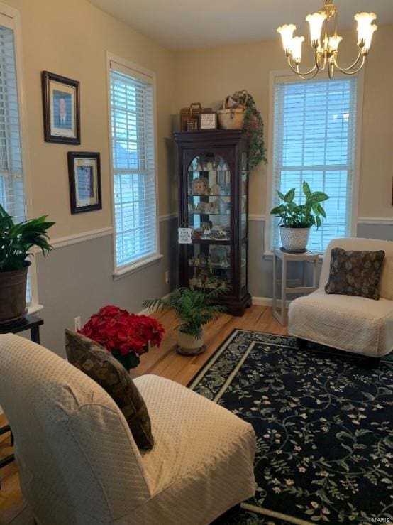 902 S Sutton Pl, Kennett, MO 63857 - sitting room featuring a chandelier and wood finished floors