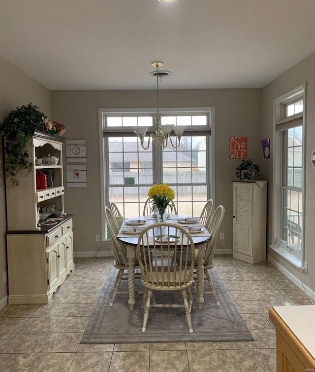 902 S Sutton Pl, Kennett, MO 63857 - dining room featuring baseboards, a chandelier, and light tile patterned floors