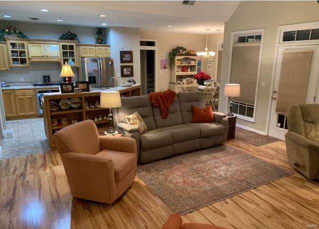 902 S Sutton Pl, Kennett, MO 63857 - living area featuring a chandelier, light wood-style flooring, and recessed lighting