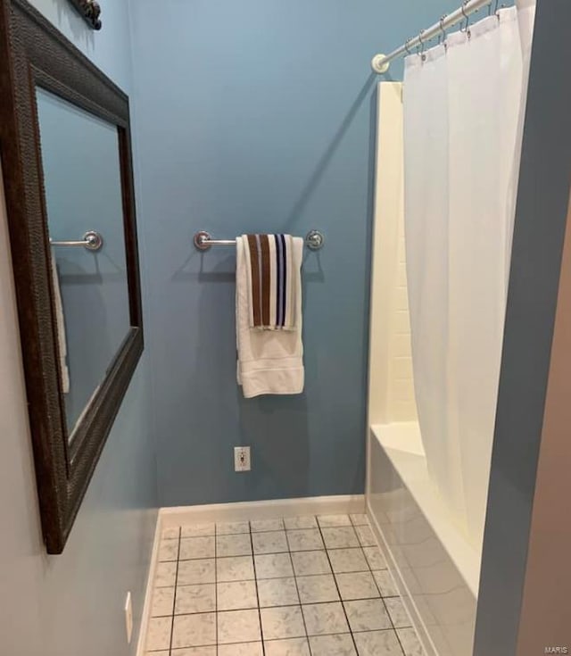 902 S Sutton Pl, Kennett, MO 63857 - full bathroom featuring baseboards, tile patterned floors, and shower / bath combo