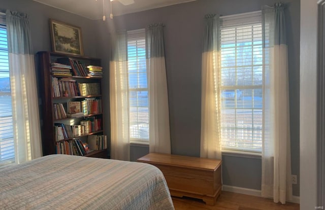 902 S Sutton Pl, Kennett, MO 63857 - bedroom with multiple windows and wood finished floors