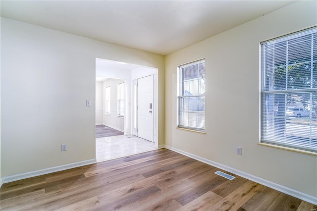 unfurnished room with wood finished floors and baseboards