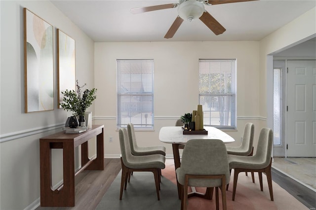 dining area with wood finished floors, plenty of natural light, and ceiling fan