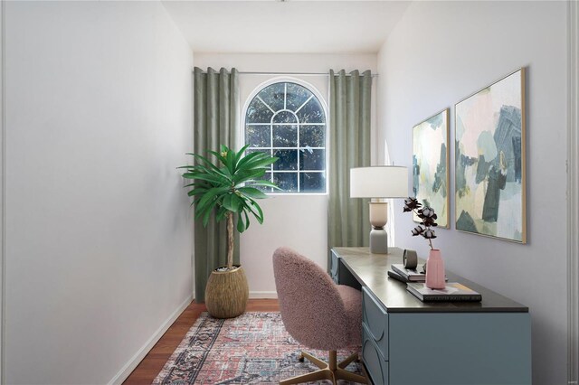 office with dark wood-type flooring and baseboards