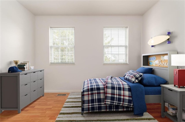 bedroom featuring light wood-style flooring and baseboards