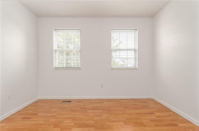 unfurnished room featuring light wood-style floors and baseboards