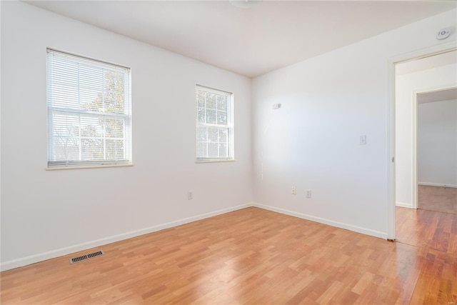 empty room featuring light wood-style floors and baseboards