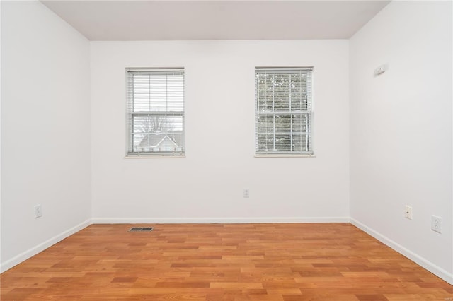 empty room featuring light wood-style floors and baseboards